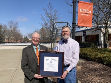 Provost Todd Pfannestiel presents the Paul Young Award to Professor Jeffrey Miller.